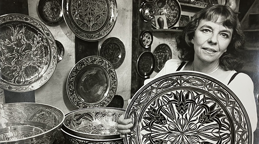 Image of a woman surrounded by ceramic plates